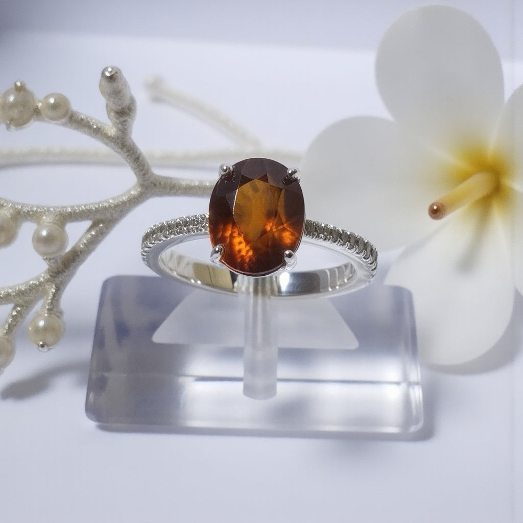 Sterling Silver Ring with Oval Garnet and Cubic Zircon Accents